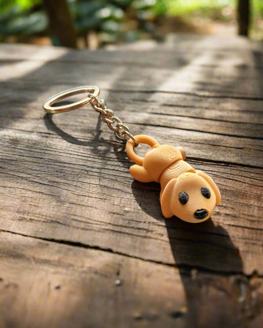 Hand holding a keychain with a dog-shaped charm against a blurred background