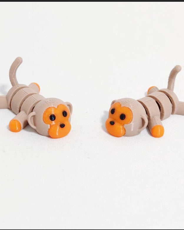 Two toy animals resembling cats on a white background