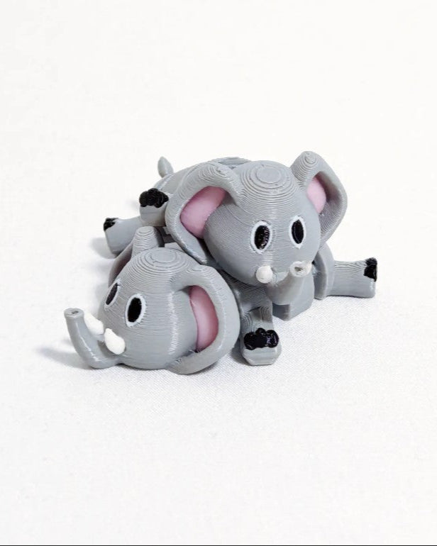 Gray elephant toy with pink interior on a white background