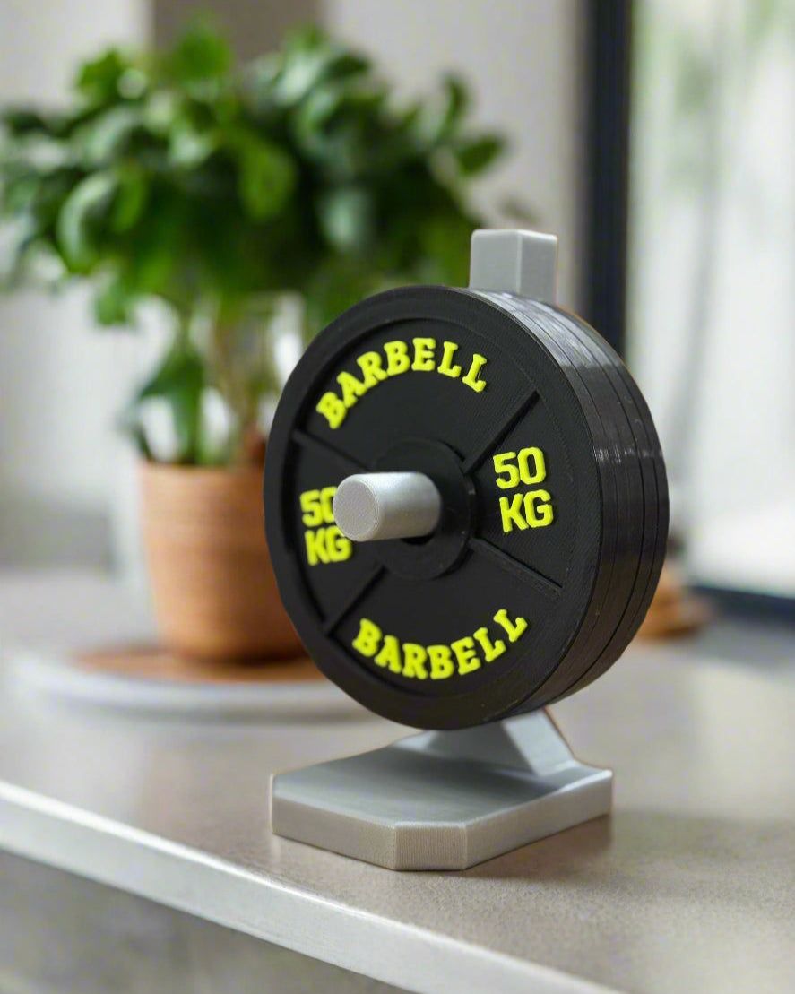 Barbell weight plate with colorful dumbbells in the background