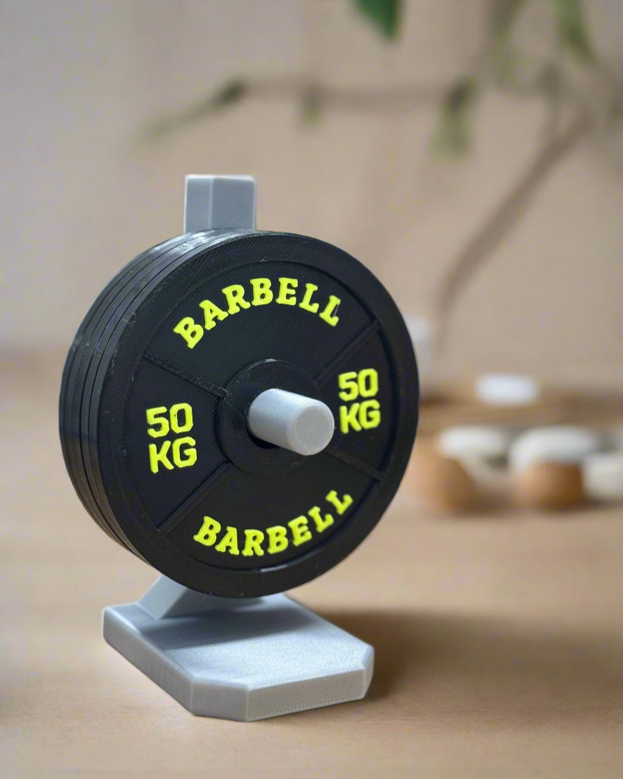 Barbell with colorful weight plates on a wooden surface