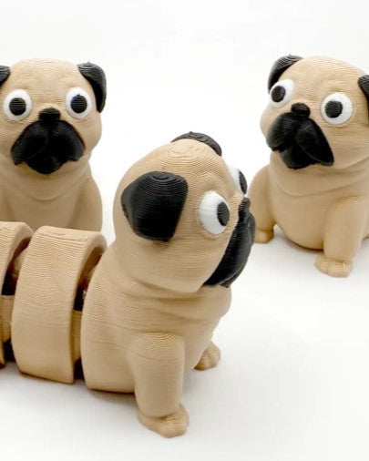 Three pug-shaped keychains on a white background