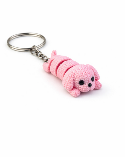 Pink caterpillar-shaped keychain on a white background