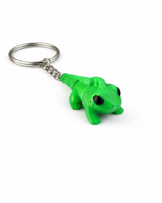 Green frog-shaped keychain on a white background