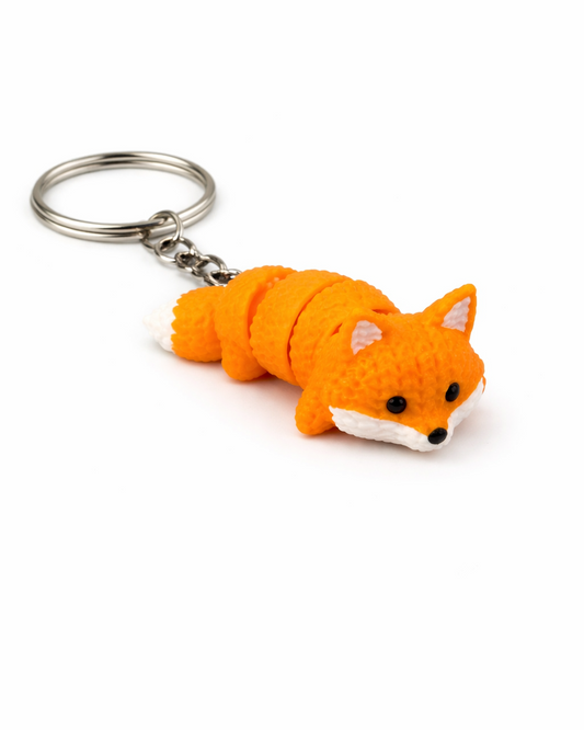 Orange fox-shaped keychain on a white background