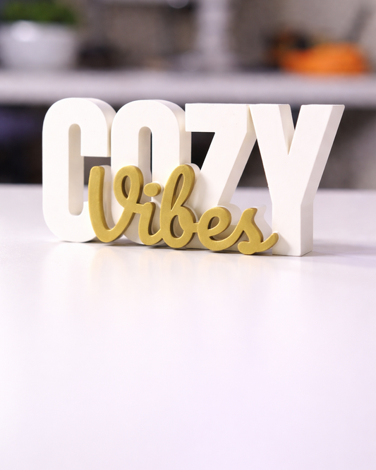 Decorative sign with 'GOZY Vibes' text on a white surface