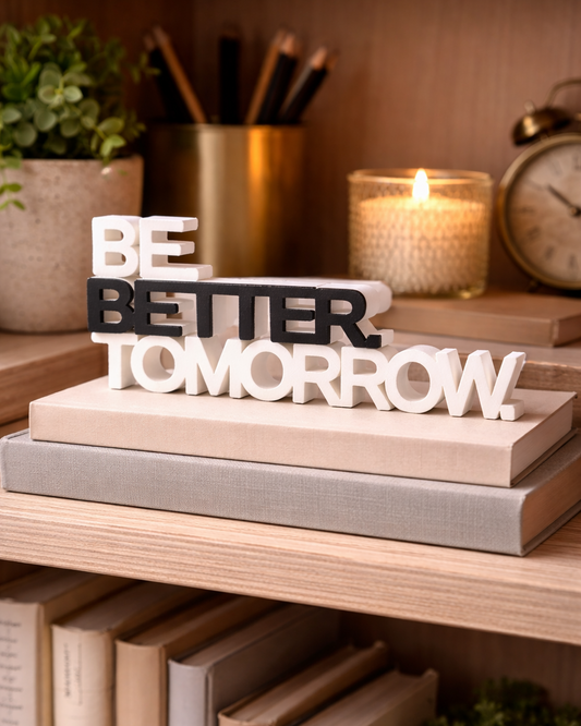 Decorative sign on books with motivational text in a home setting