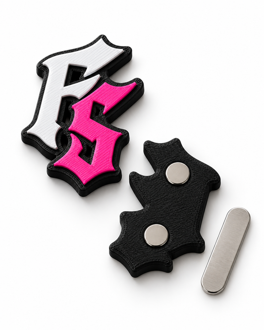 3D printed magnetic badge close-up showing raised colour lettering