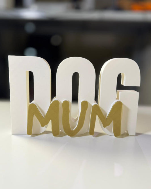 Decorative sign with 'DOG MUM' text on a white surface