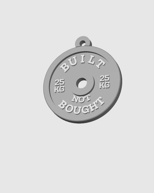 Gray weight plate with 'Built Not Bought' text on a light gray background