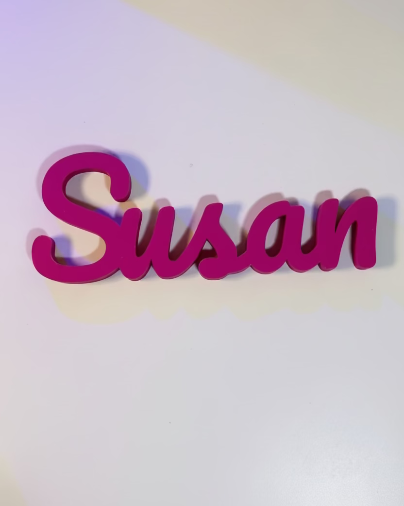 Pink 'Susan' sign on a white wall