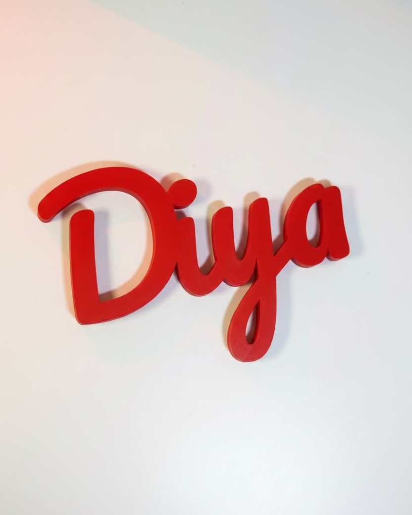 Red decorative word 'Diya' on a white wall