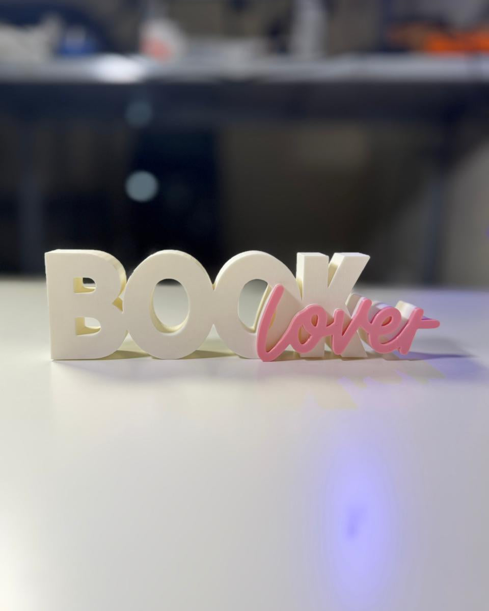 Decorative sign with 'BOOK lover' on a blurred background