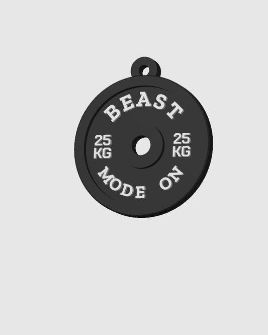 Black weight plate with 'BEAST MODE ON' text on a gray background