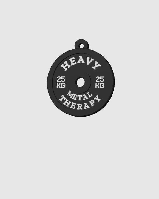 Black weight plate with 'Heavy Metal Therapy' text on a light gray background