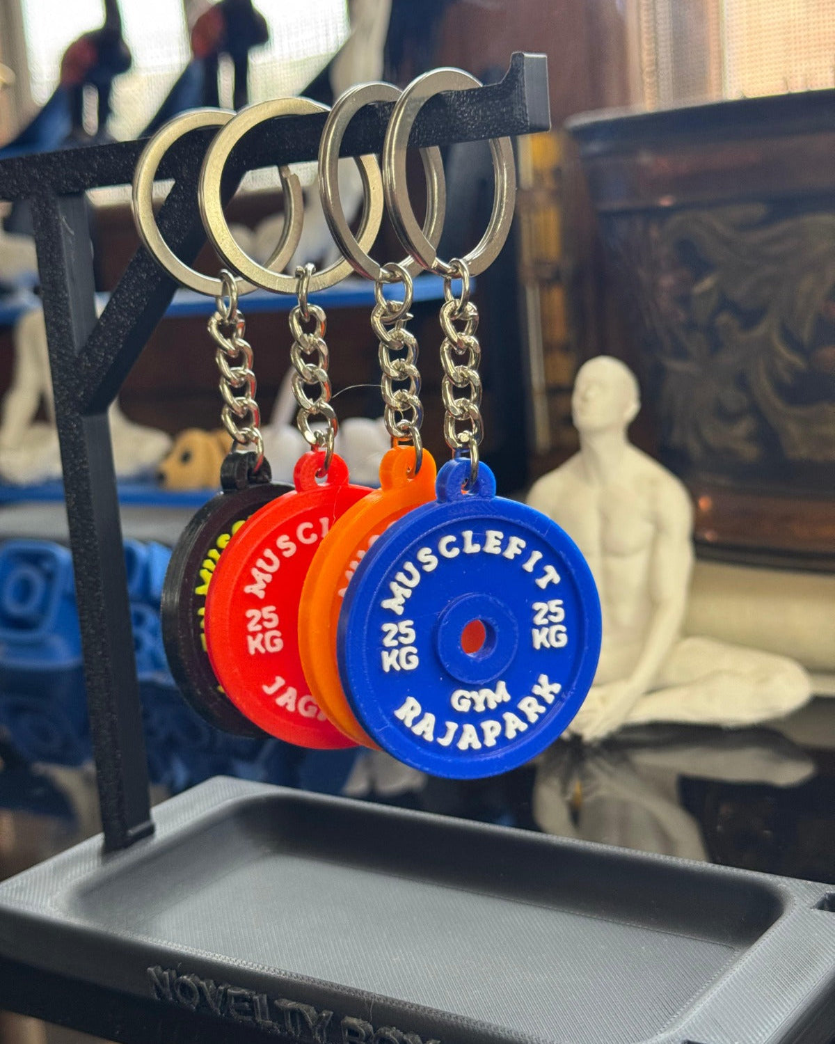 Keychain display with colorful keychains on a stand, blurred background