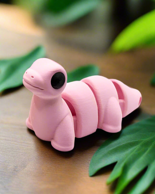 Pink dinosaur-shaped clip on a white background