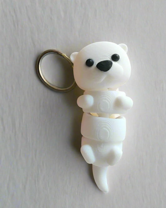 White polar bear figurine held in a hand with a blurred background