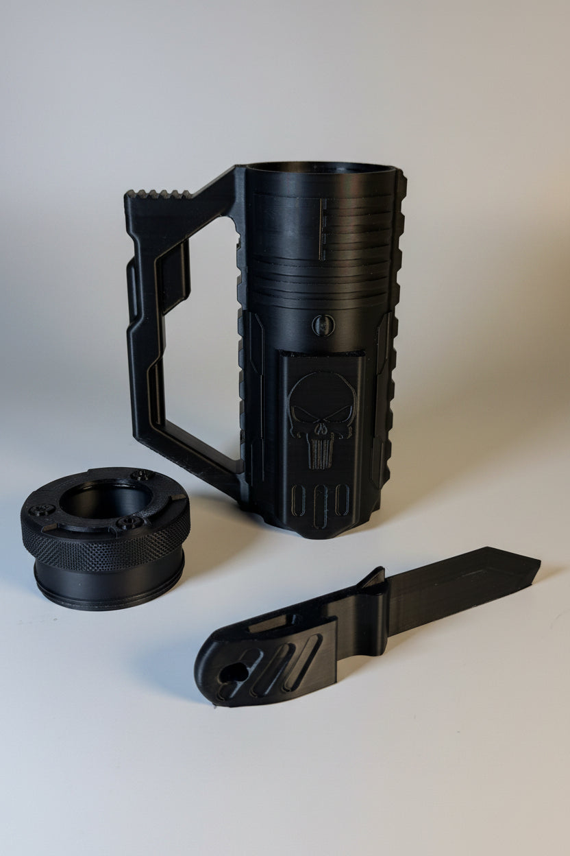 Black mug with Punisher logo, black cap, and black knife on a white surface.