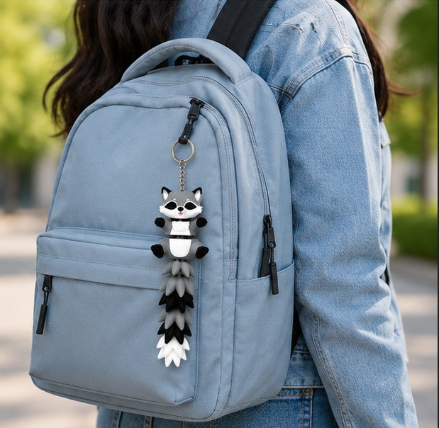 Raccoon charm on backpack