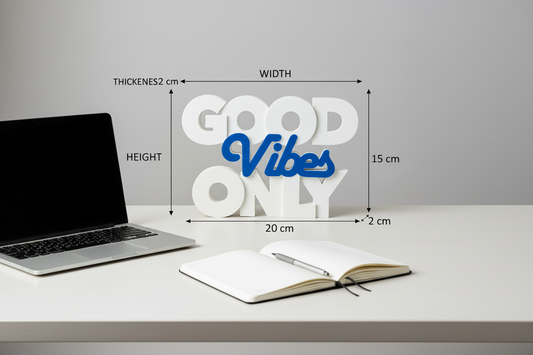 Decorative sign with 'Good Vibes Only' text on a desk with measurements displayed.