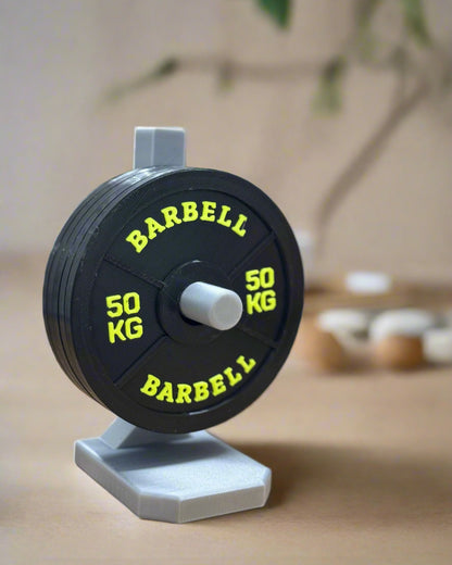 Barbell with colorful weight plates on a wooden surface