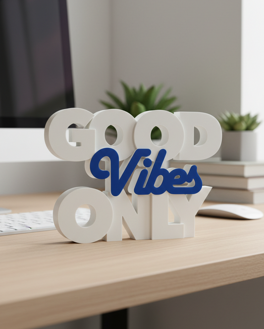 Decorative sign with 'Good Vibes Only' on a desk in an office setting