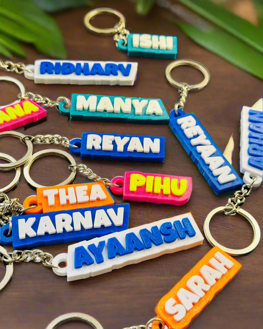 Colorful keychains with names on a dark surface