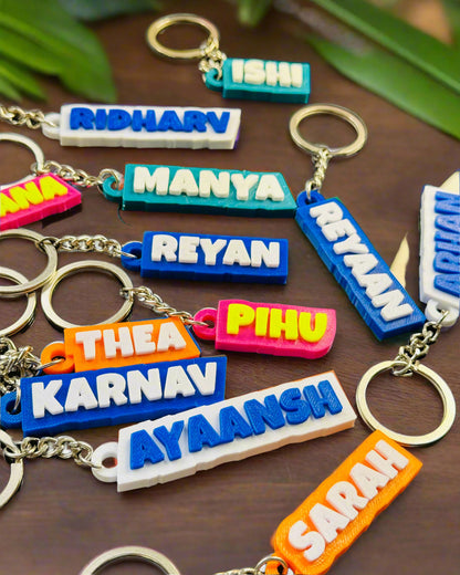 Colorful keychains with names on a dark surface