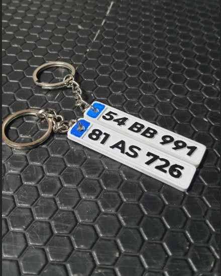Keychain with license plate design on a textured black surface