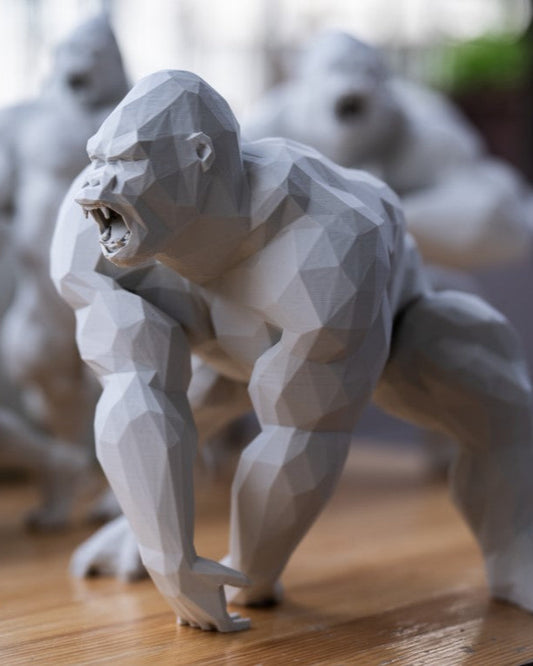 Geometric gorilla sculpture on a wooden surface with blurred background